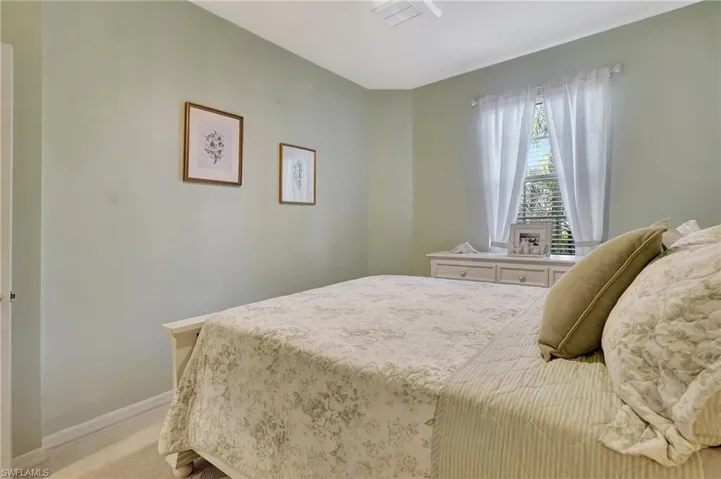 Bedroom featuring light colored carpet