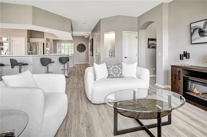 Living room with sink and light wood-type flooring