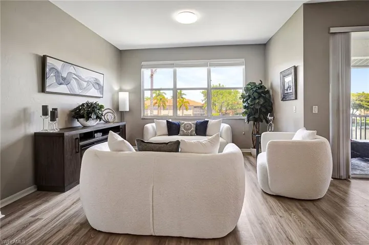 Living room with hardwood / wood-style flooring and a healthy amount of sunlight
