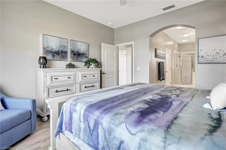 Bedroom with ceiling fan and light wood-type flooring