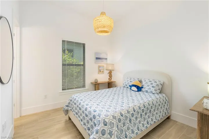Bedroom featuring wood tiled floors and baseboards