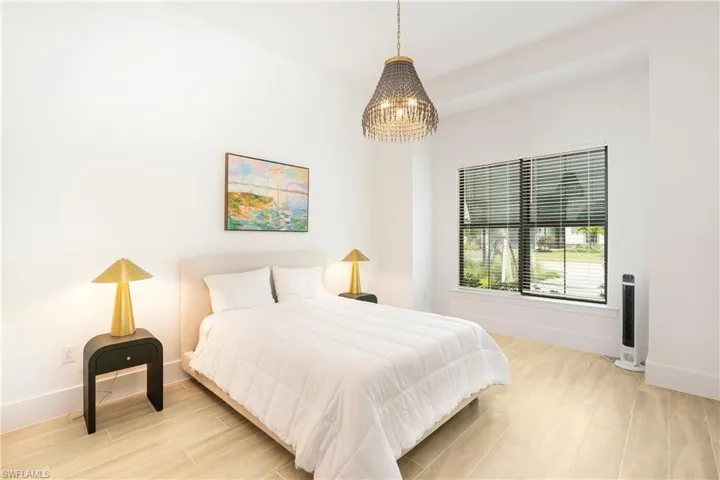 Bedroom featuring light wood finished floors and baseboards