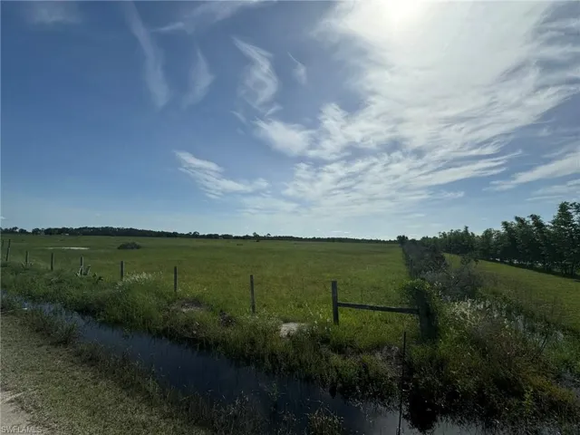 View of yard with a rural view