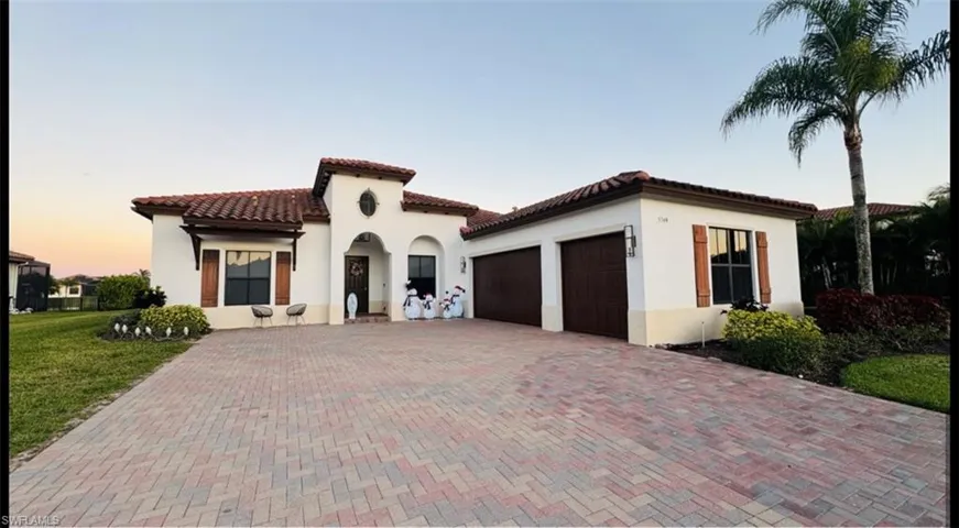 Mediterranean / spanish-style home featuring a garage, stucco siding, decorative driveway, and a tile roof