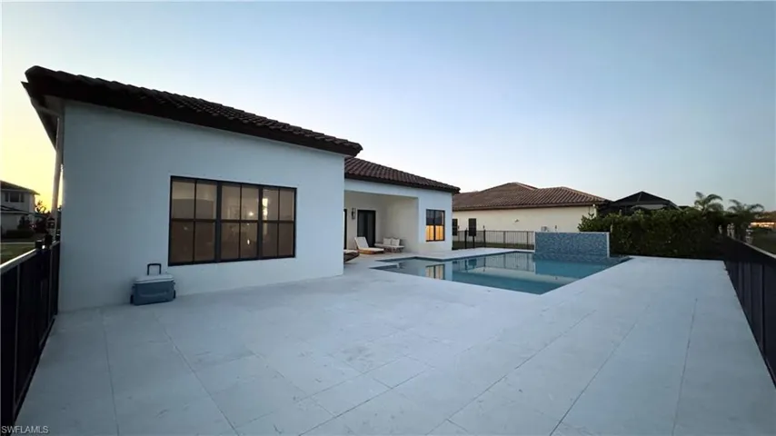 View of swimming pool with a patio area and a fenced backyard