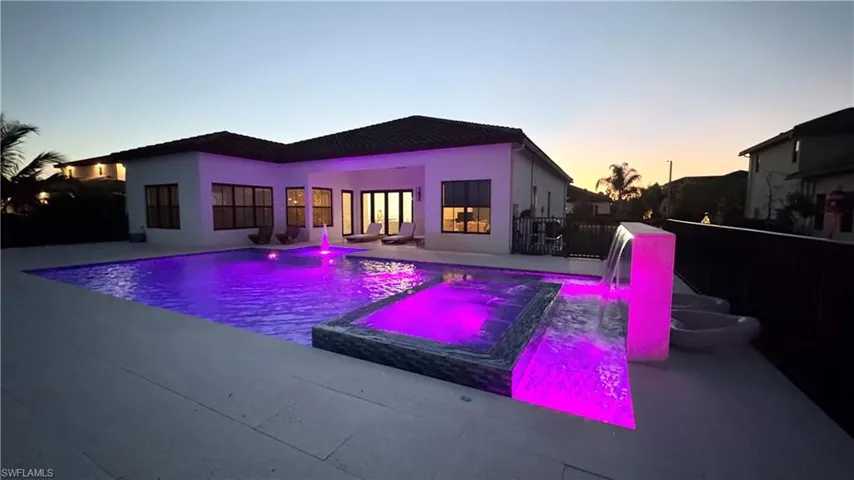 View of pool featuring a pool with connected hot tub and a patio area