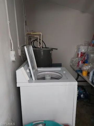 Laundry room featuring washer / clothes dryer and water heater