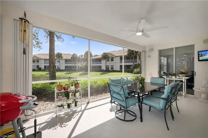 Screened Lanai with outdoor dining area and ceiling fan