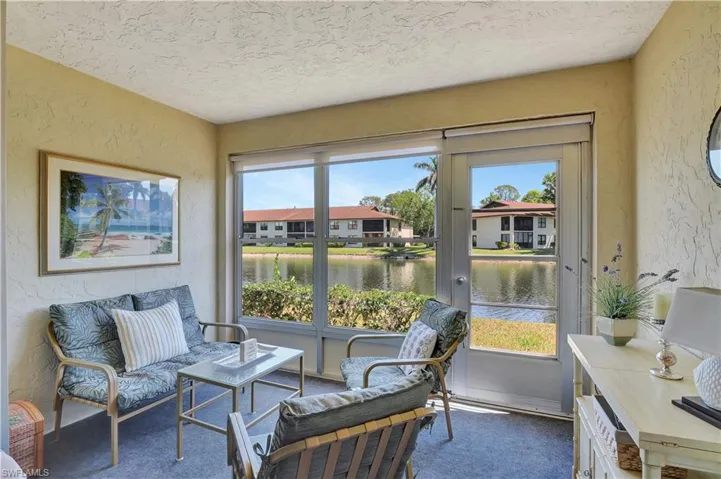 Sunroom featuring plenty of natural light and a water view