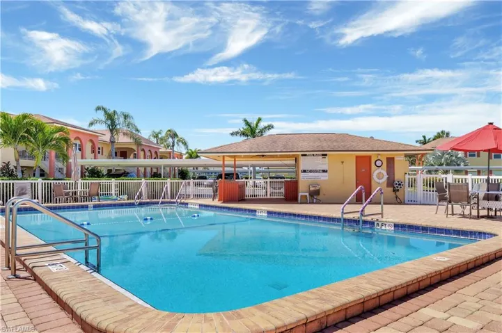 Pool featuring fence and a patio area