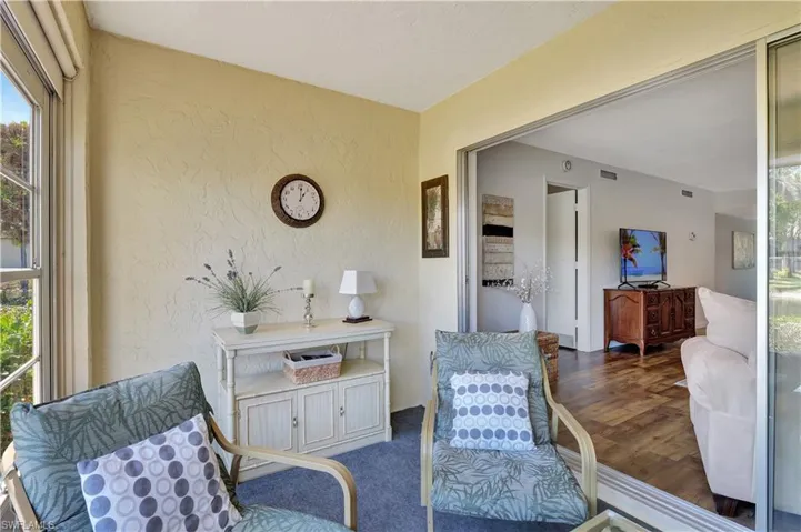 Sunroom featuring plenty of natural light and a water view