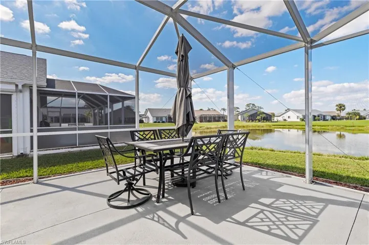 Sunroom / solarium featuring a water view