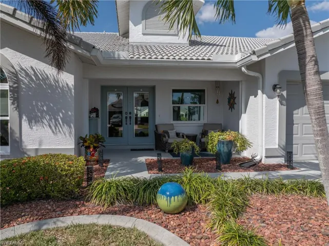 Property entrance featuring french doors