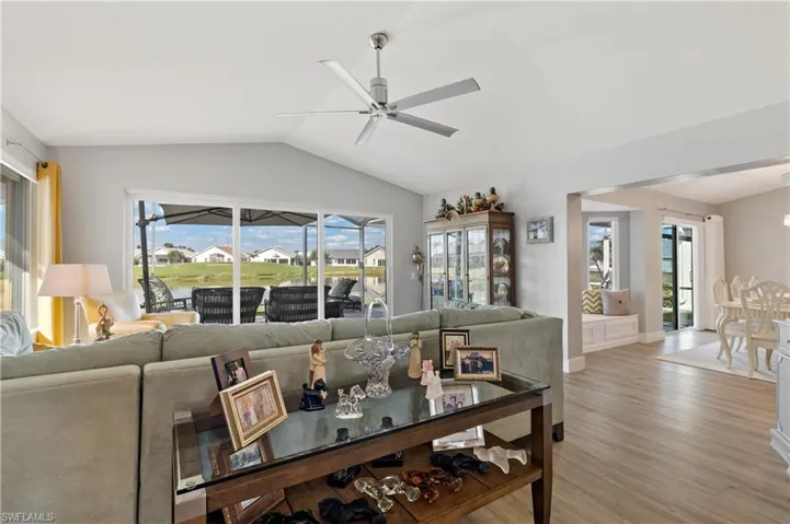 Living room featuring lofted ceiling, light hardwood / wood-style floors, and ceiling fan