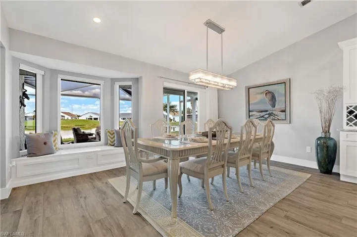 Dining space featuring lofted ceiling and light hardwood / wood-style floors