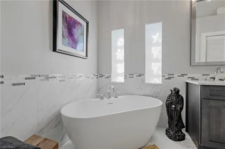 Bathroom with vanity and a bathtub