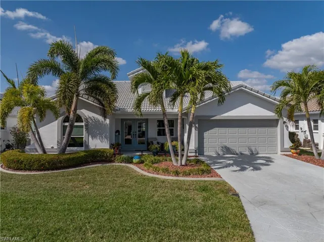 View of front of home featuring a garage, a front lawn, and french doors