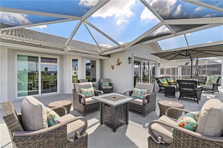 View of patio with an outdoor living space and a lanai