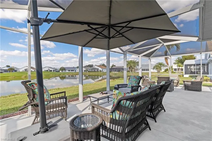 View of patio featuring a water view, an outdoor hangout area, and a lanai