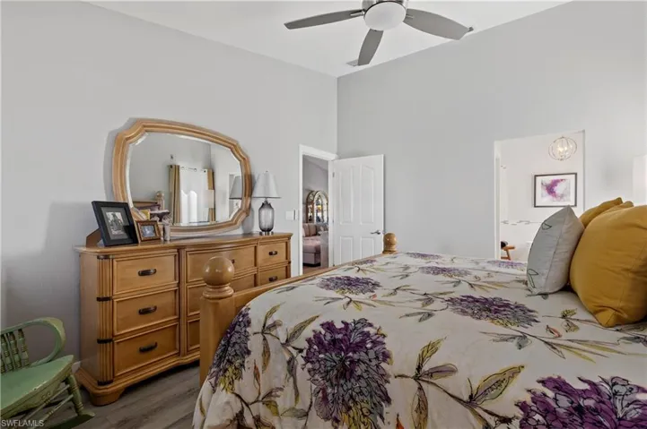 Bedroom with ceiling fan and dark hardwood / wood-style flooring