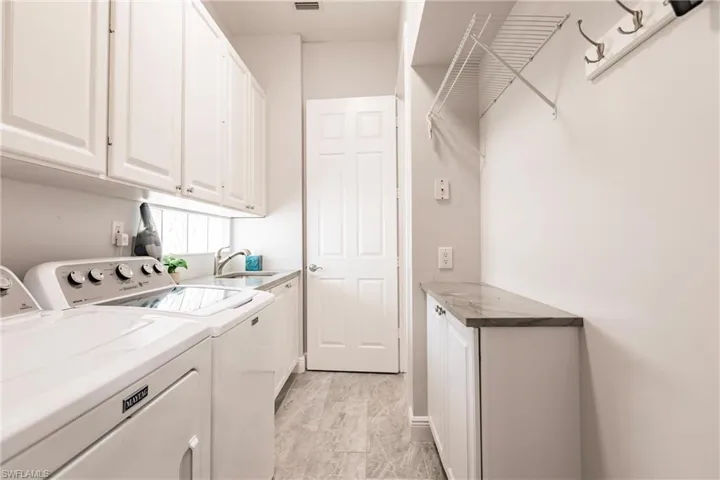Laundry room leads to garage.