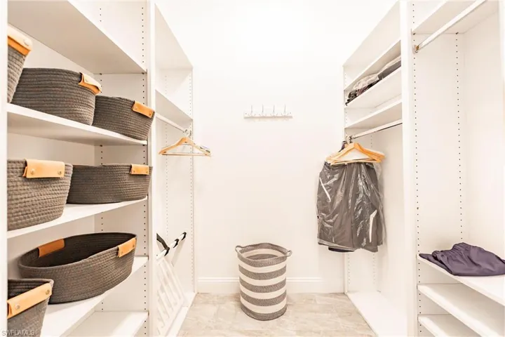 The walk-in closet has adjustable shelving and clothes rods.