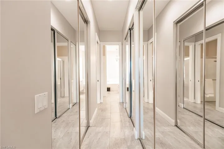 Hall of closets leads to his and hers bathroom.
