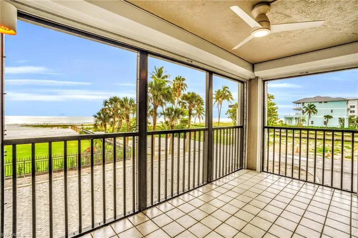 Unfurnished sunroom featuring ceiling fan