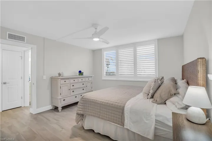 Bedroom featuring ceiling fan and light hardwood tile tilewood-style floors