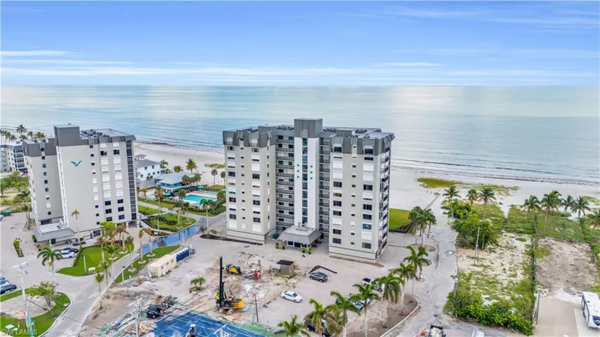 Drone / aerial view featuring a beach view and a water view