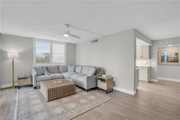 Living room featuring light wood-type flooring and ceiling fan