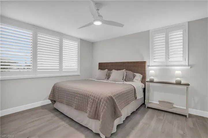 Bedroom featuring ceiling fan and light hardwood  tile floors