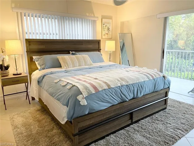 Bedroom with tile patterned floors and access to outside