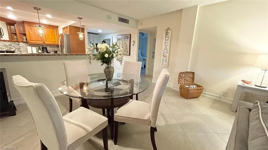 Dining area with recessed lighting and light tile patterned floors