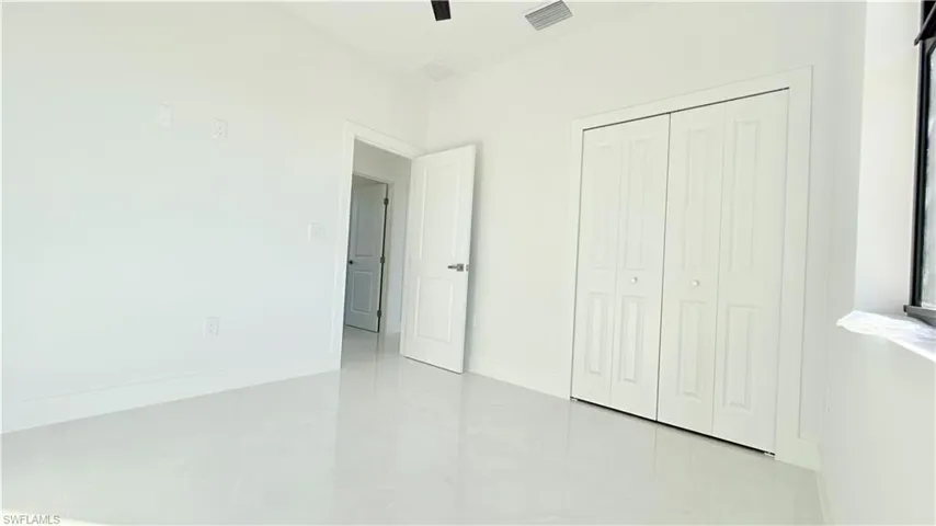 Unfurnished bedroom with a closet and a ceiling fan