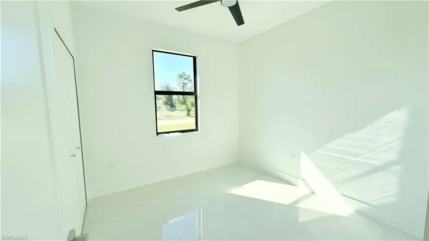 Unfurnished bedroom with baseboards and a ceiling fan