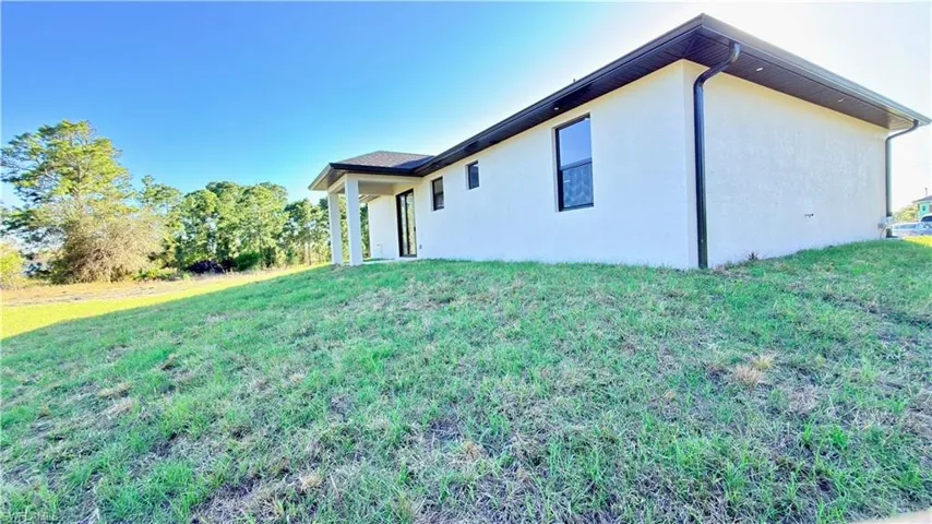 View of home's exterior featuring a yard and stucco siding
