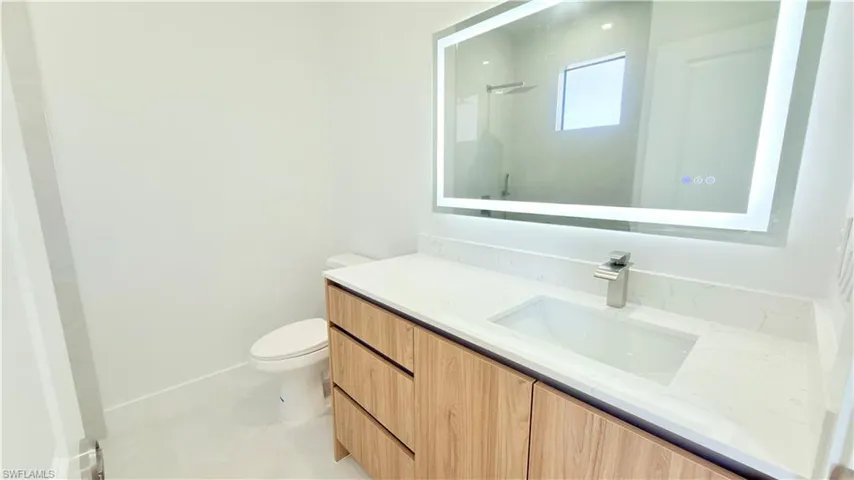 Bathroom featuring vanity and a shower