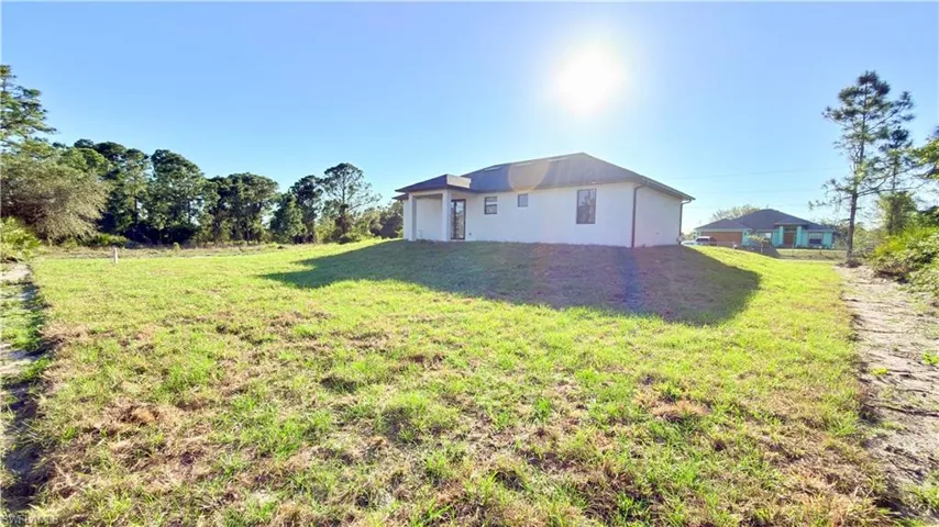 View of side of property with a yard