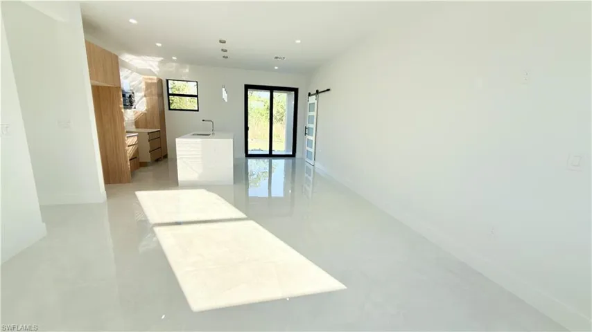 Spare room featuring a barn door and recessed lighting