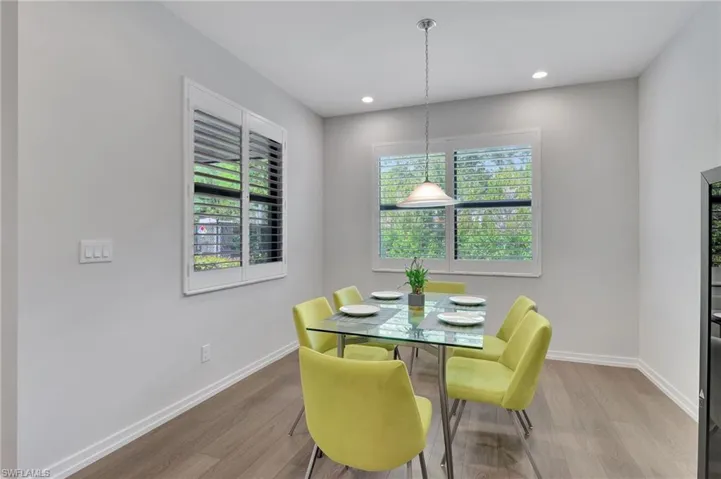Dining space with a healthy amount of sunlight and light hardwood / wood-style floors