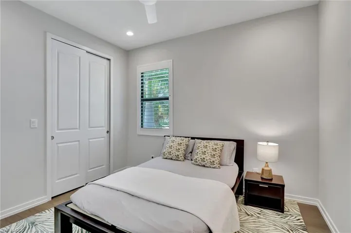 Bedroom with ceiling fan, a closet, and hardwood / wood-style floors