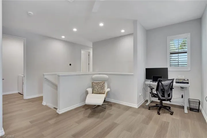 Home office with light wood-type flooring