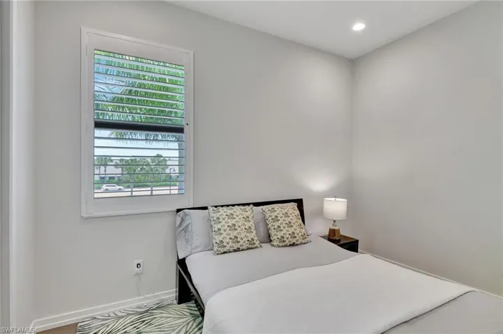 Bedroom with hardwood / wood-style floors