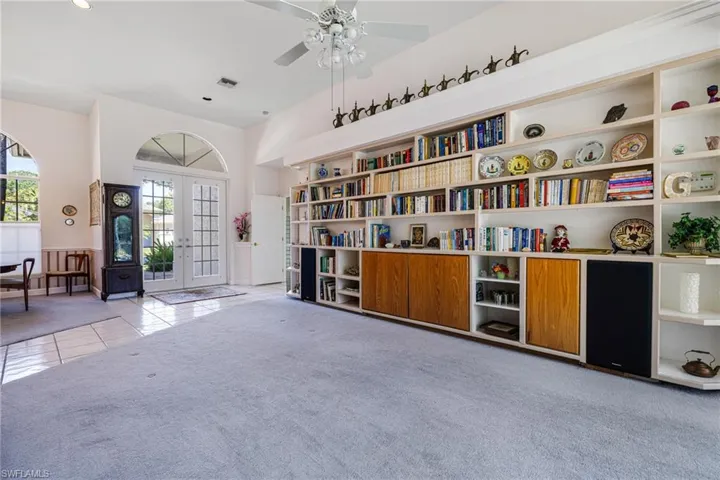 Unfurnished room with a ceiling fan, visible vents, french doors, tile patterned floors, and carpet flooring