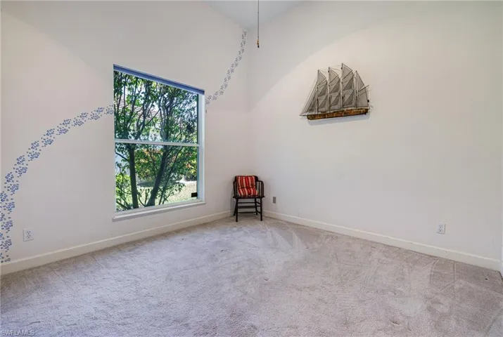 Carpeted spare room with baseboards
