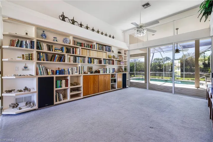 Sitting room with carpet, visible vents, and ceiling fan