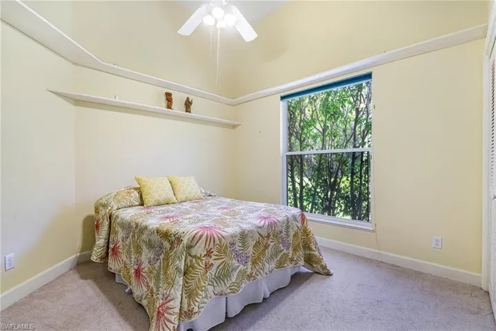 Bedroom with baseboards, carpet floors, and ceiling fan
