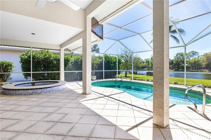 Outdoor pool featuring a patio area, glass enclosure, and a ceiling fan