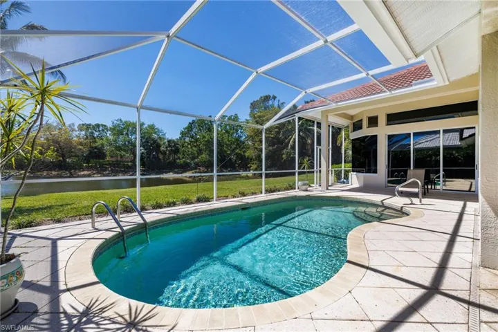 Outdoor pool with glass enclosure and a patio